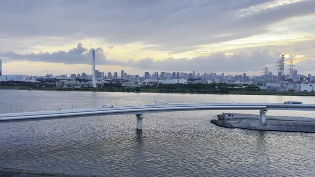 Evening Urban River Scene with Expressway Traffic and Shimmering Water in Tokyo Japan 4K