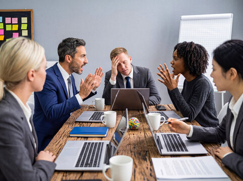 Diverse business team in a corporate meeting actively engaged in a heated discussion and debate photograph.