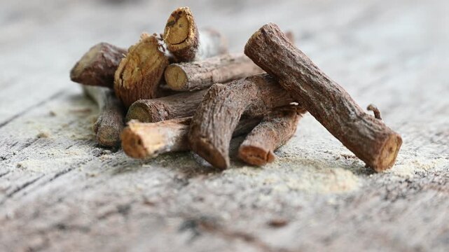 ayurvedic mulethi or liquorice root stick or jeshthamadh powder on wooden background