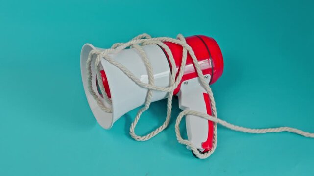 Thick Rope Is Pulled Away From Megaphone On Blue Surface For Removal Of Barriers To Free Speech