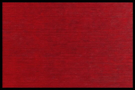 Red textured background with horizontal lines. Subtle pattern resembles fabric or fine corduroy. Simple clean backdrop with even tonal variation.