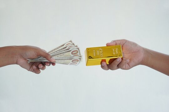 Gold buying and selling transactions using dollars. Exchanging money for gold. The concept of investing in gold with dollars.