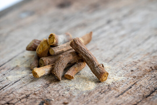 ayurvedic mulethi or liquorice root stick or jeshthamadh powder on wooden background