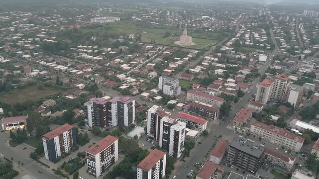 Drone view new and old apartment blocks in Zugdidi residential district with cathedral background. Concepts: real estate, housing, urban growth, investment, development, infrastructure, lifestyle