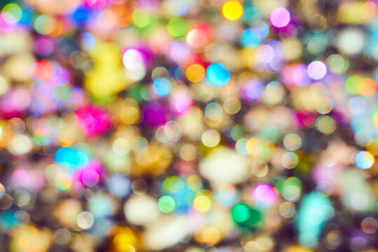 Vibrant multi-colored bokeh background with soft out of focus light circles. Festive abstract texture for holiday design.
