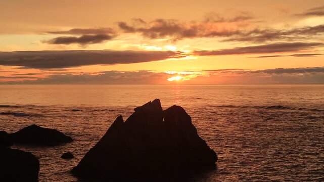 Sunset over the East China Sea with rocky coast in Amami Oshima, Japan