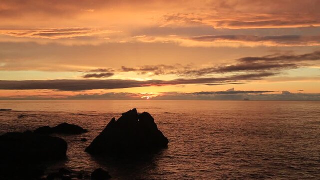 Sunset over the East China Sea with rocky coast in Amami Oshima, Japan