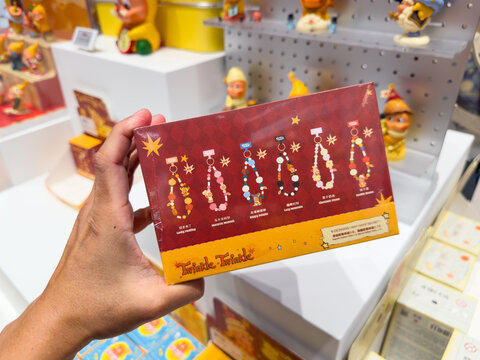 KUALA LUMPUR, MALAYSIA - FEB 01, 2026: Hand holding a full box of Pop Mart Twinkle Twinkle Savor the Moment Phone Charm Blind Box showing the varieties