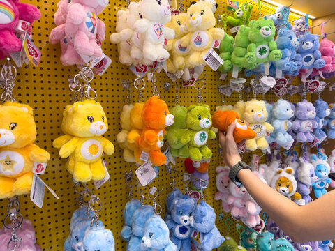 KUALA LUMPUR, MALAYSIA - FEB 02, 2026: Care Bears plush keychains displayed on retail store pegboard wall in colorful character merchandise section.