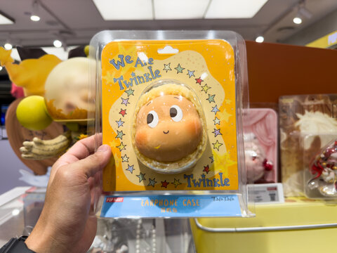 KUALA LUMPUR, MALAYSIA - FEB 01, 2026: Hand holding a Pop Mart Twinkle Twinkle earphone case packaged in clear blister packaging on display in a retail store setting.