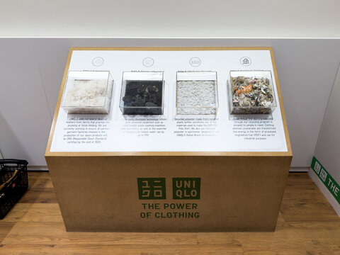 KUALA LUMPUR, MALAYSIA - FEB 02, 2026: Uniqlo sustainability display stand featuring recycled material samples inside retail store.