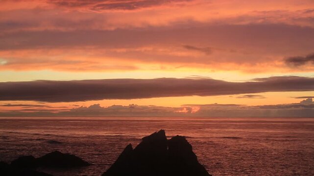 Sunset over the East China Sea with rocky coast in Amami Oshima, Japan