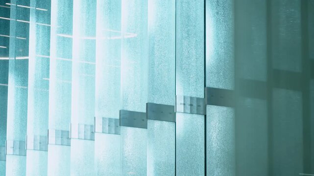 Frosted glass panels form a textured partition in modern corporate office interior