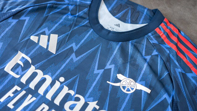 Bangkok, Thailand - 7 May 2026; Adidas is present the Arsenal FC away team jersey for season 2025-2026. It coming in deep blue color with thunderbolt pattern and metallic silver emblem. Close-up.