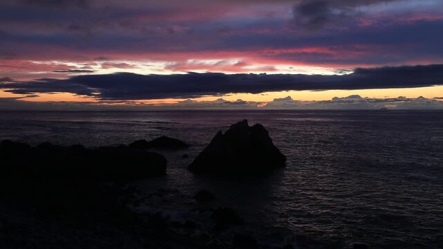 Sunset over the East China Sea with rocky coast in Amami Oshima, Japan