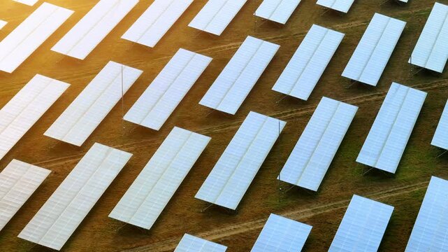 Aerial view from drone of a modern solar energy farm producing clean electricity for communities and industries, helping decrease greenhouse gas emissions and encouraging sustainable development. 4k.

