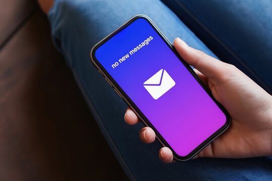 Person holds smartphone displaying no new messages notification. Close up of mobile device screen. Concept of communication silence and waiting for digital contact.