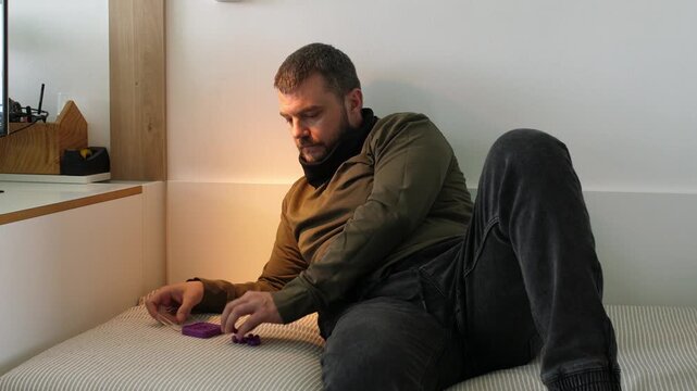 Focused man solving a tangram puzzle