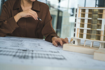 Female Architect Analyzing Modern Building Model © PIC SNIPE