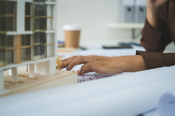 Female Architect Analyzing Modern Building Model © PIC SNIPE