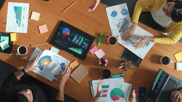 Top view of attractive diverse team clapping hands while project manager present creative idea at meeting room. Diverse team working together planning marketing strategy at meeting room. Convocation.