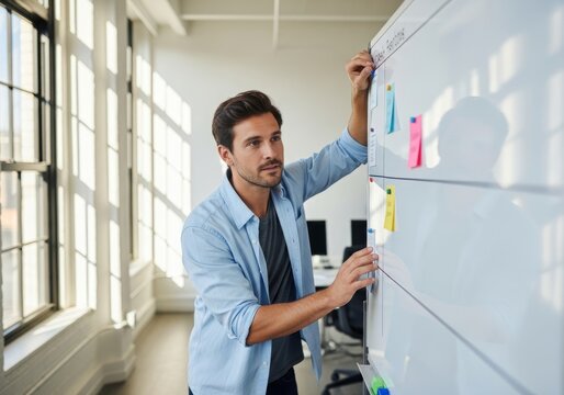 Man Planning on Task Board in Modern Office with Sunlight - Business Strategy