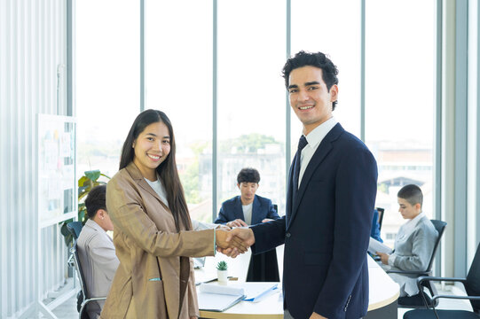Young business people are shaking hands after a business deal. Successful negotiations or interview.