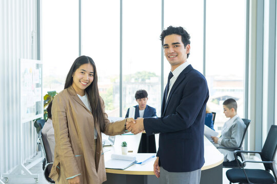 Young business people are shaking hands after a business deal. Successful negotiations or interview.