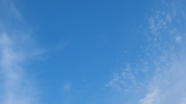 A blue sky timelapse video footage featuring scattered altocumulus clouds across a vivid atmosphere, capturing gentle airflow, fresh daytime weather, soft textures, and peaceful natural motion. 4k.
