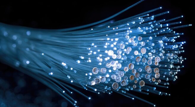 Glowing strands of optic fibers radiate blue light against a dark backdrop