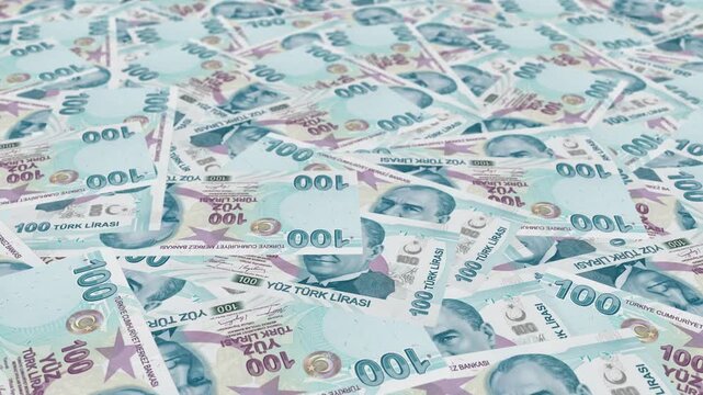 Close-up high angle view of scattered 100 Turkish Lira banknotes, Republic of Turkey official currency, Turkish Lira inflation and economy concept editorial.