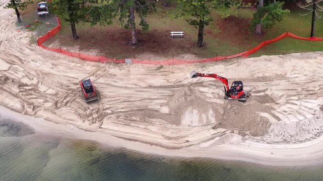 Aerial View of Excavators Renovating a Sandy Canal Beach in Australia