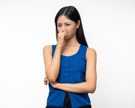 Bad smell stinks. Young beautiful asian woman pinching nose with disgust. Holding breath with fingers on nose