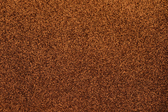 Close up texture of a reddish brown granular surface for background use