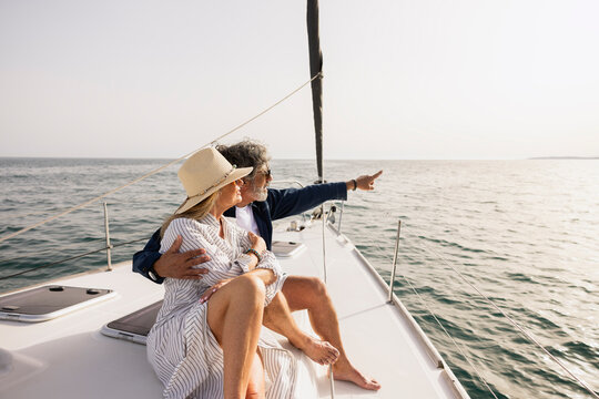 Senior couple sailing enjoying ocean view on yacht vacation