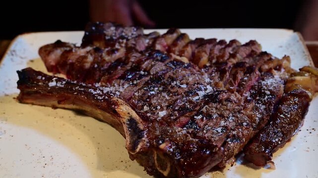 Delicious grilled t-bone beef steak serving at a restaurant