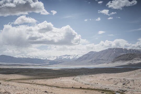 Mountain landscape with a view of a rocky mountain ridge with snow and glaciers in the highlands of Tajikistan in the Pamirs. A panorama of the Tien Shan Mountains for background