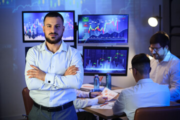 Fototapeta premium Portrait of male trader in office at night