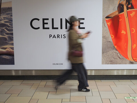 TOKYO, JAPAN - May 6, 2026: Person passing a billboard in Omotesando subway station advertising Celine.