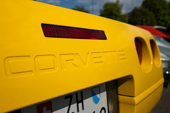 Zurich, Switzerland, April 19, 2026. A close up shot of the embossed lettering on the rear bumper of a yellow Corvette at Albisguetli Classics.