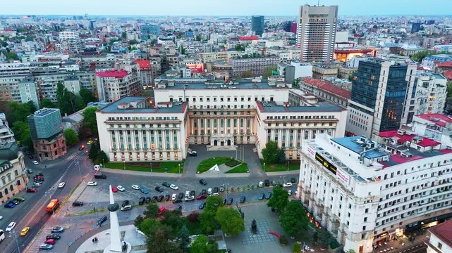 Drone push shot toward the Ministry of Internal Affairs Palace in Revolution Square with glowing evening lights.
