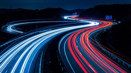 Curving highway at night showcasing captivating light trails from vehicles. © Jacqueline