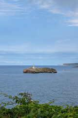 Fototapeta premium Wonderful view of the calm sea from the promenade in Santander, Spain, with soft waves and a peaceful coastal atmosphere.
