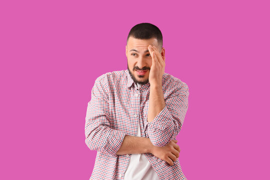 Apologetic young man on violet background