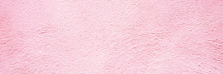Fototapeta premium Wall of pink texture in a bright and open space with natural light shining during the day in the city setting