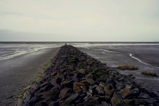 Long row of stones serving as breakwaters in the North Sea