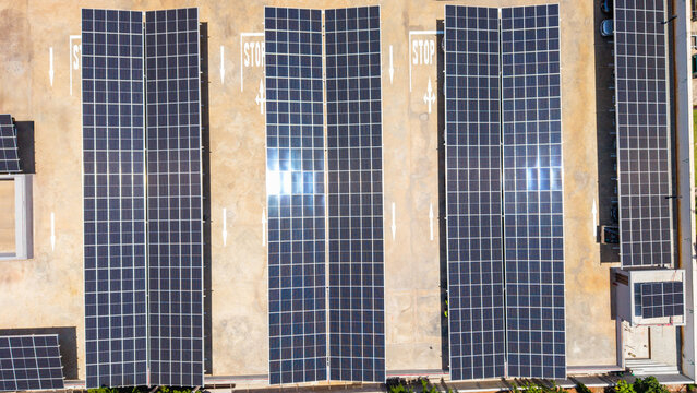 Aerial view of solar panels covering a parking lot, generating sustainable power