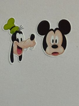 Mickey Mouse and Goofy character stickers displayed on white background. May 8 2026. Alberta, Canada. For editorial use only.