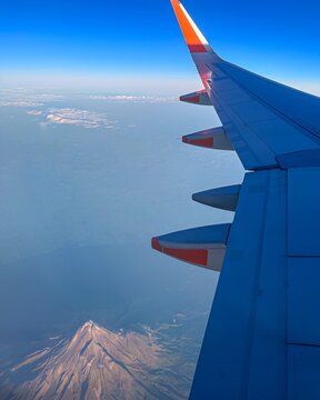 Aerial view of Mount Taranaki volcano from airplane window, New Zealand