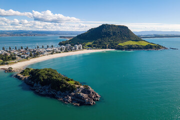 Fototapeta premium Mount Maunganui, New Zealand. An aerial view of Moturiki Island, part of Mount Maunanui town, and Mauao, the mountain at the end of the peninsula